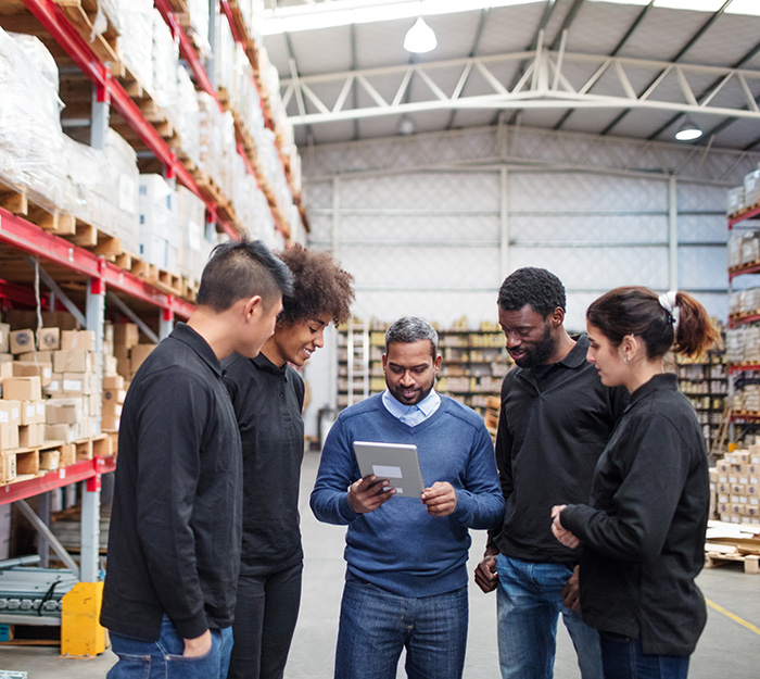 A group of people looking at results on a tablet