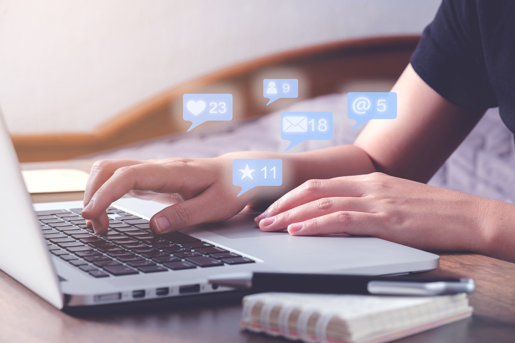 A man sitting at a laptop using with notifications popping up about BCBA Exam Prep