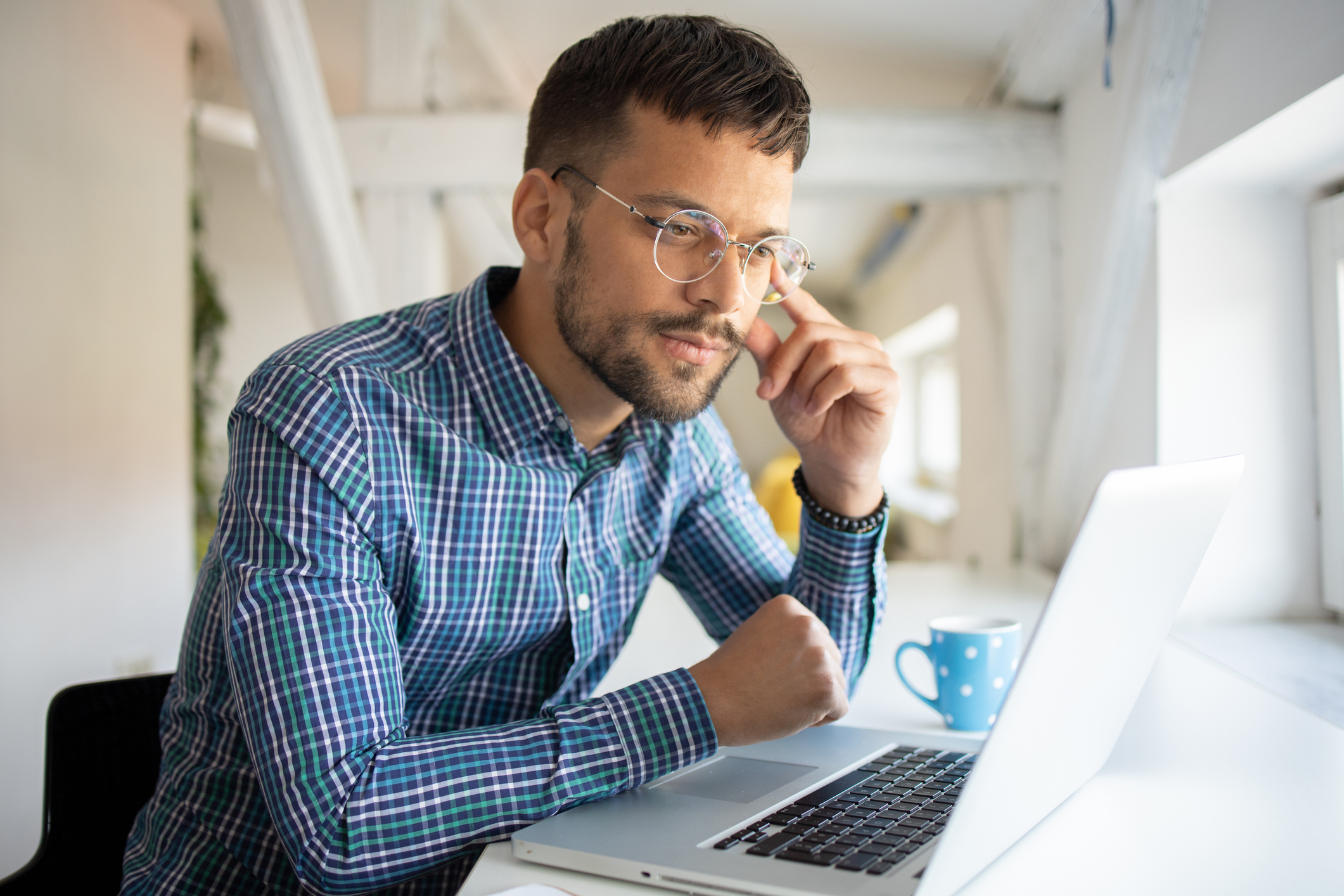 A man sitting at a laptop using BCBA Exam Prep