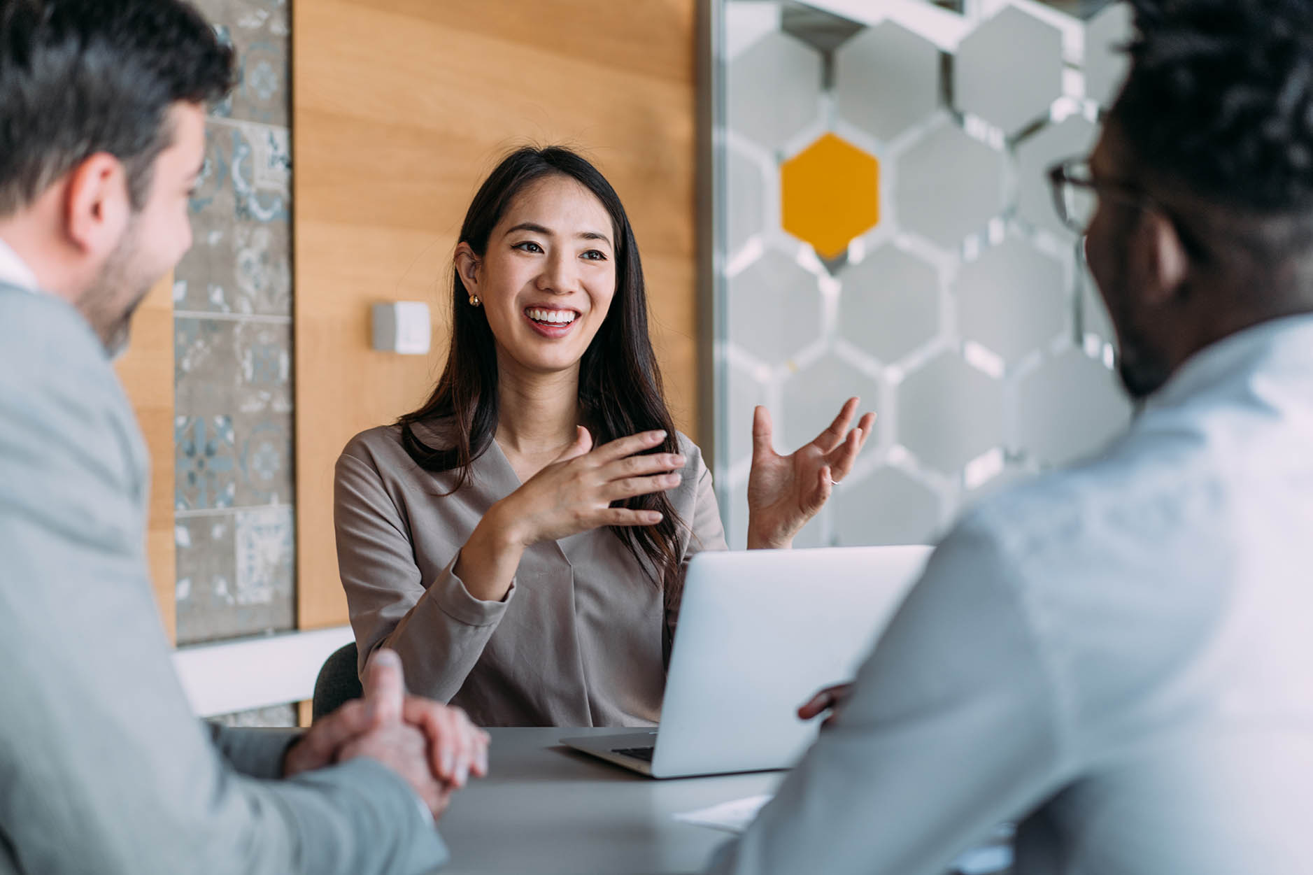 Woman meeting and presenting information to two employees