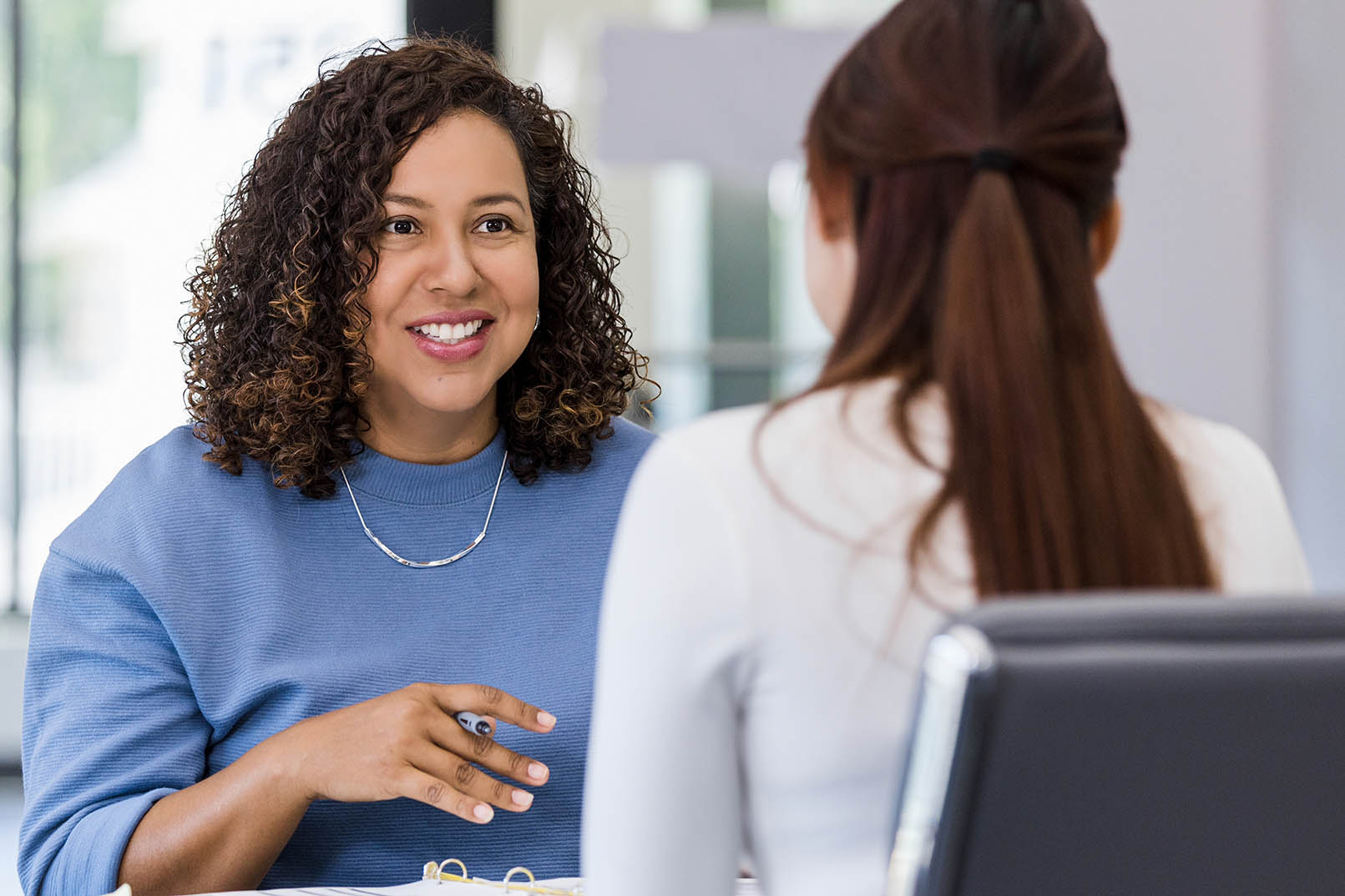 Woman presenting information/audit to another woman