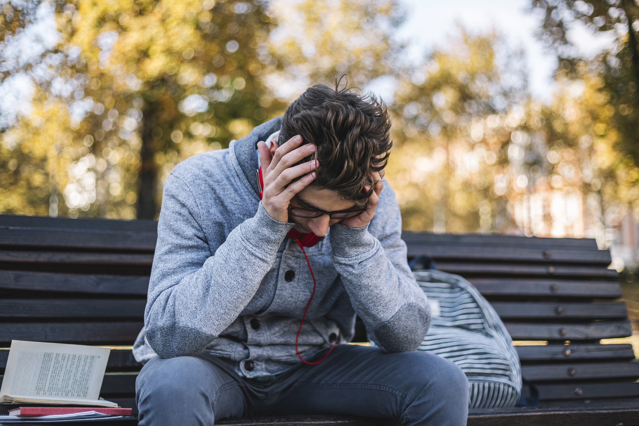 Teenager with hands on head