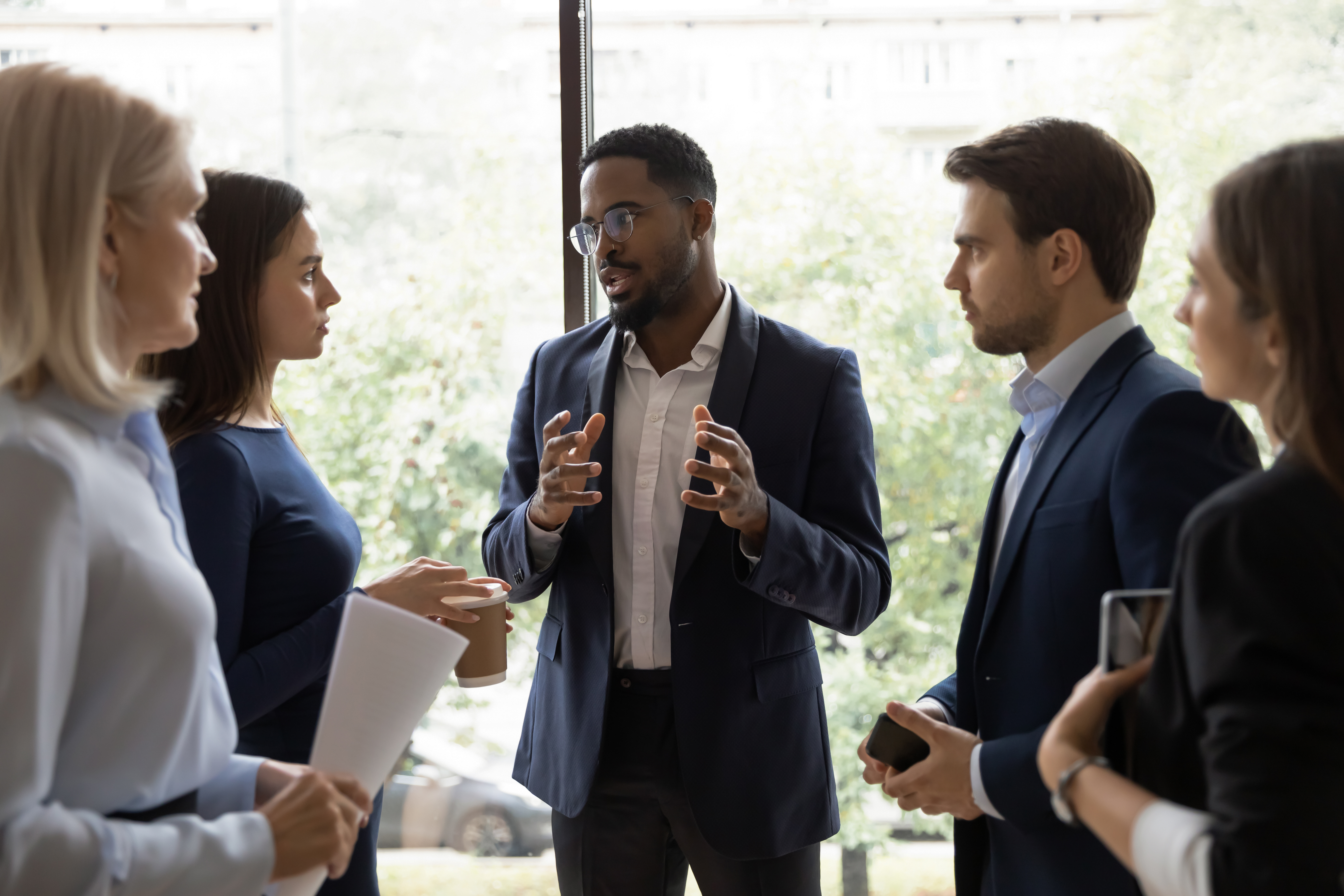 a Diverse group of business professionals holding an OBM Meeting