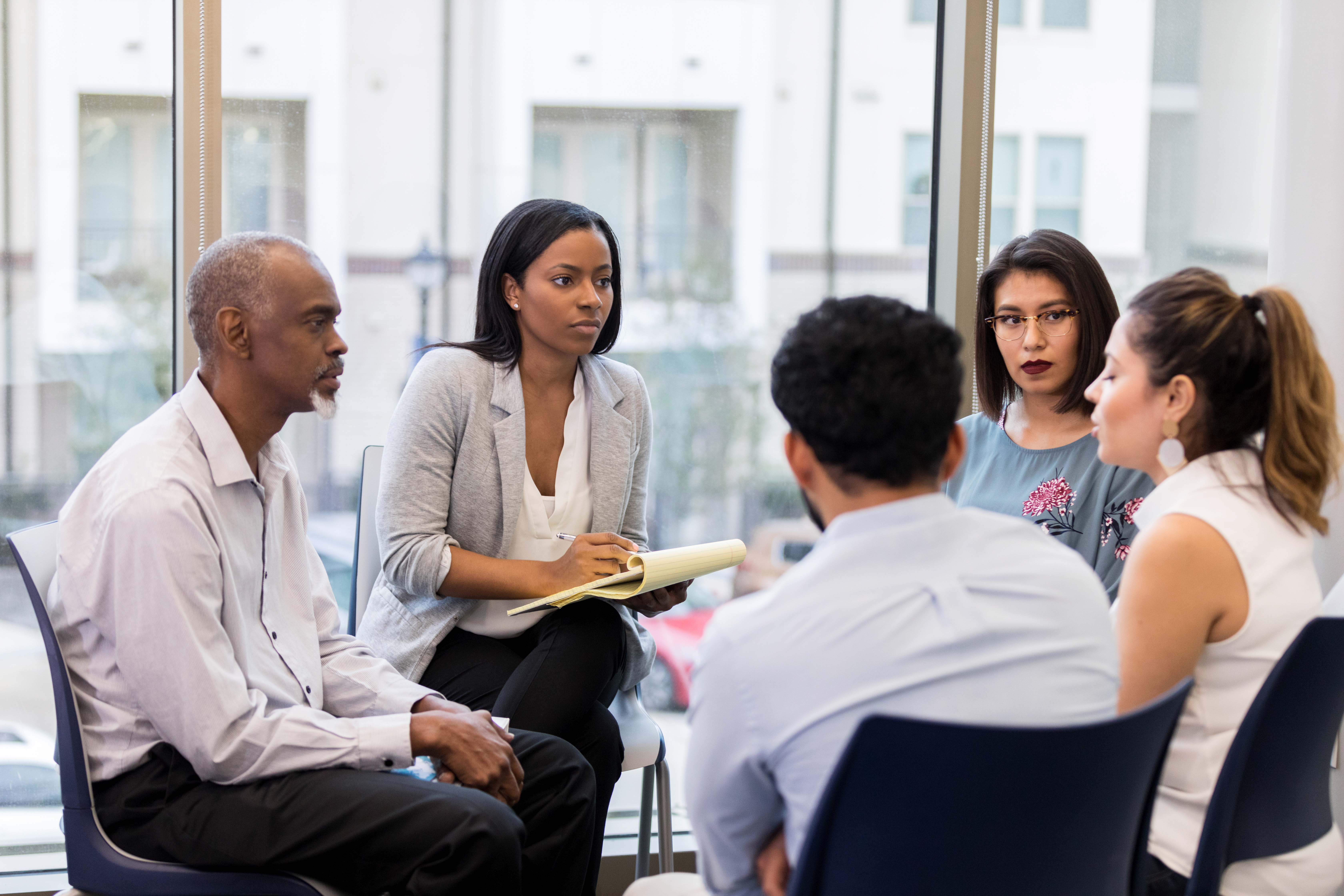 A professional working with a group of employees