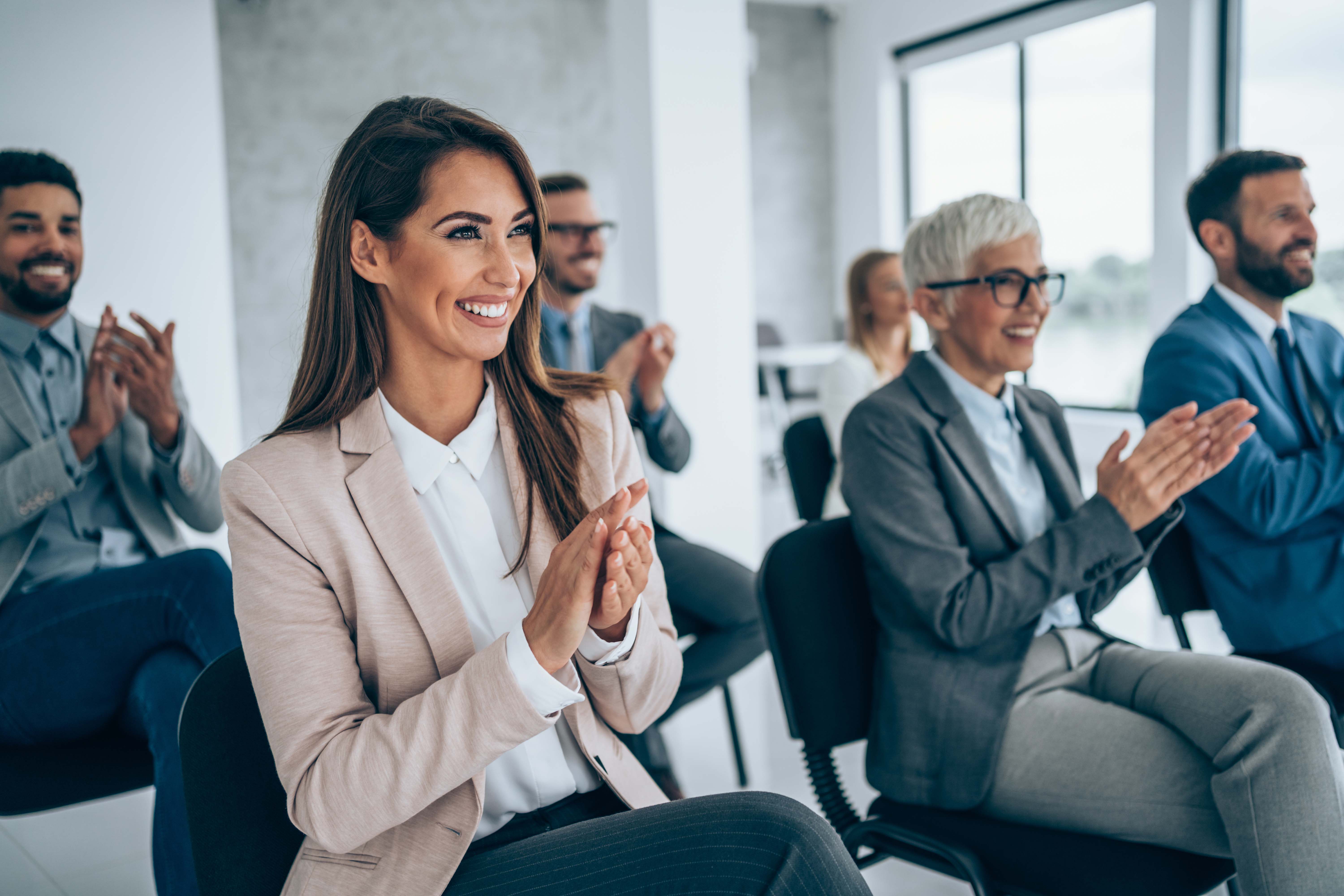 a group of people watching a presentation 