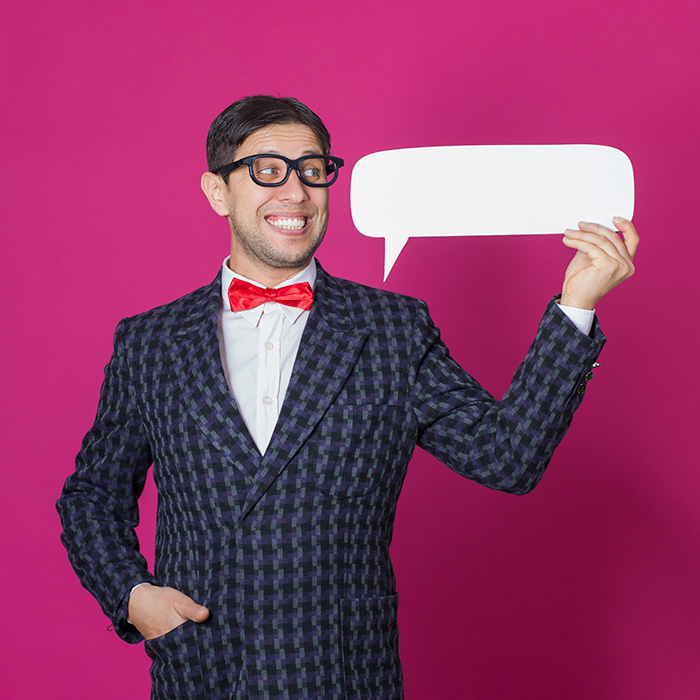 Man Wearing Glasses Holding Speech Bubble