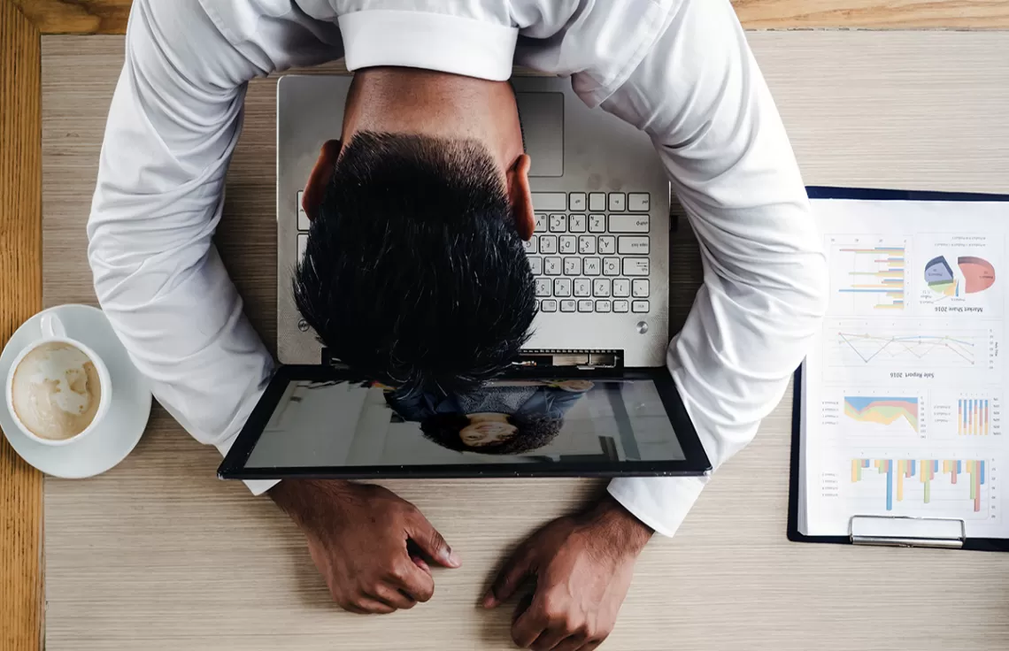 Stressed out man in front of laptop