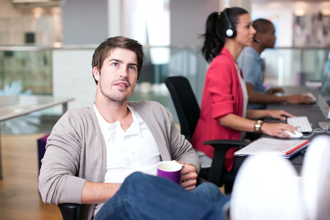 Man in office staring into space