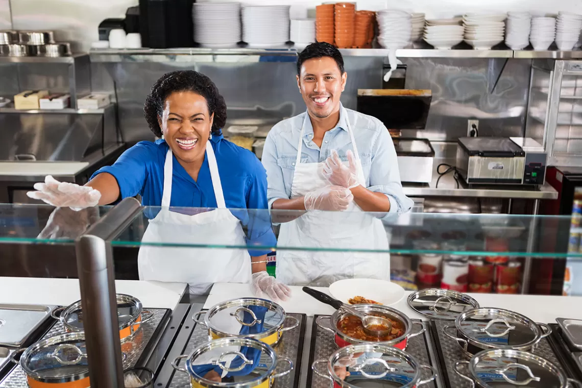 Leadership and Culture OBM series, two smiling people serving food