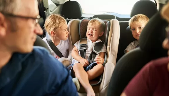 Parents with children misbehaving in the car