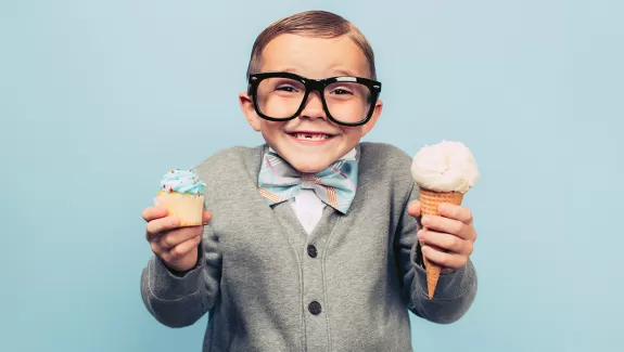 Boy with a cupcake and ice cream cone