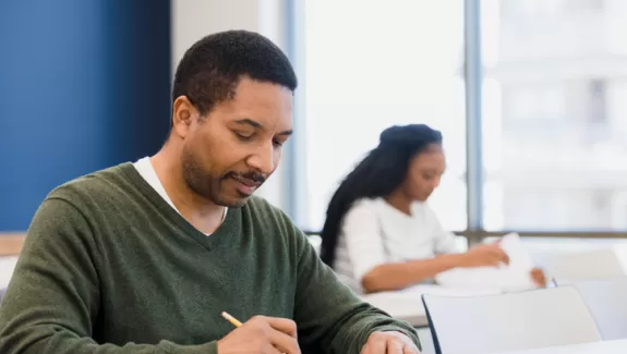 A student works on his exam during class.