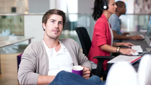 Man in office staring into space