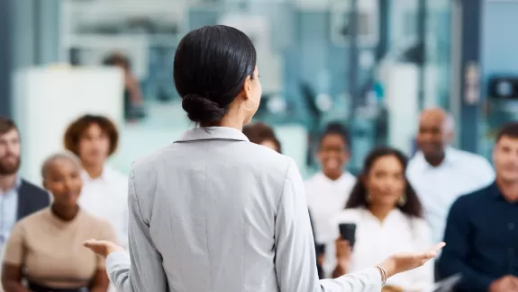 A woman presenting to a group of professionals 