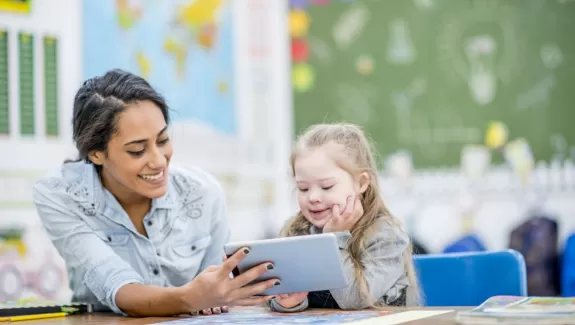 A teacher working with a child