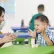 Teacher and young student clapping in a classroom 