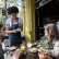 Waitress taking the order of two people sitting outdoors at a restaurant 