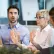 Three adults talking around a table in a work environment